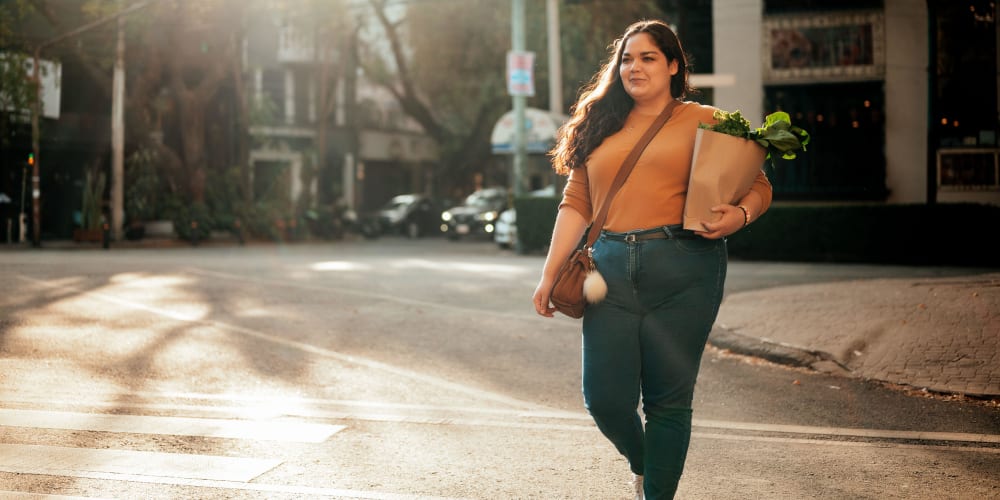 Resident carrying groceries home near Tides at Meadowbrook in Fort Worth, Texas