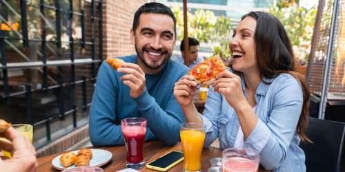 A couple having pizza in a cafe near Orange Wood Court in Sherman Oaks, California