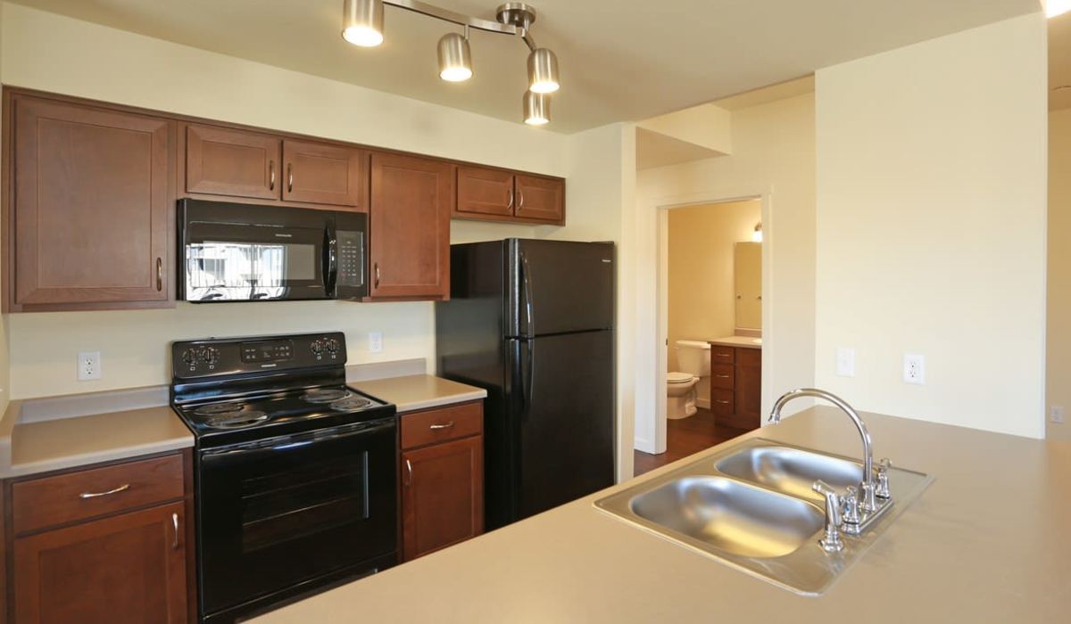 Kitchen with black appliances at Copper Stone in Lafayette, Colorado