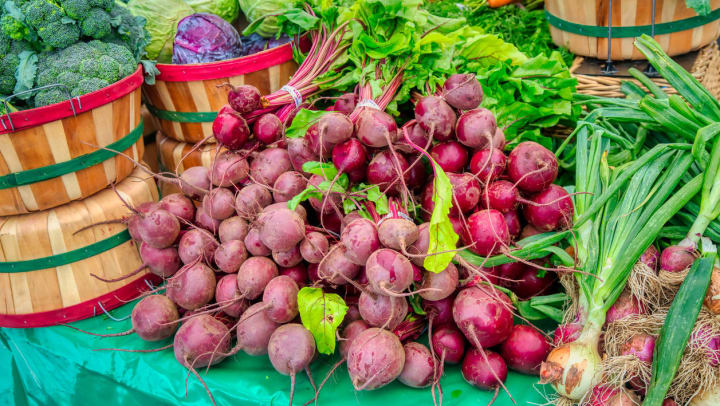 Beets, broccoli, cabbage, and more fresh produce on display at a Richmond farmers market.