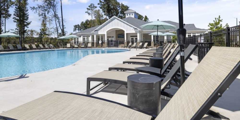 Resort-style large swimming pool with lounge chairs at Hudson at Carolina Colours in New Bern, North Carolina