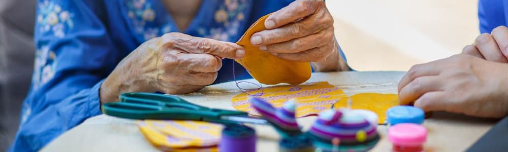Resident sewing at Maple Ridge Care Center in Spooner, Wisconsin