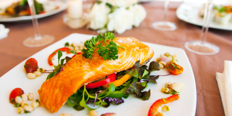 Grilled salmon with vegetables on a plate in a restaurant near Ben Moreell in Norfolk, Virginia