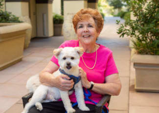 A resident with her dog at Sunset Lake Village Senior Living in Venice, Florida