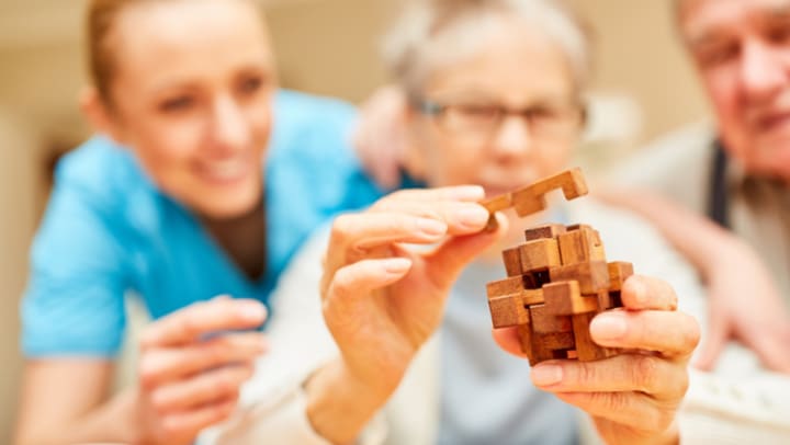 An older lady making a puzzle