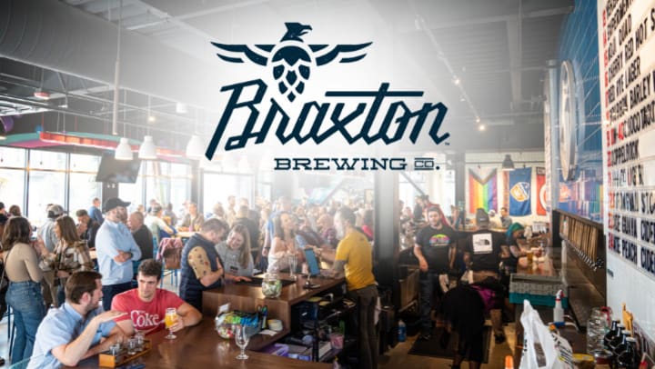 A packed taproom with people enjoying drinks at the bar and tables, featuring the Braxton Brewing Co. logo overlaid at the top of the image.