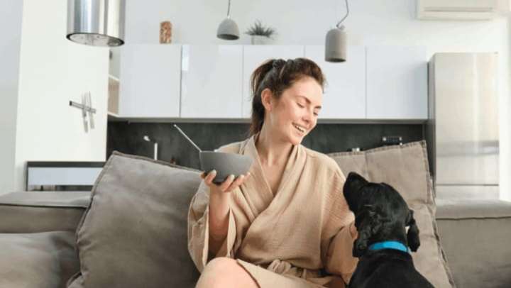 Resident with her pet in a living room