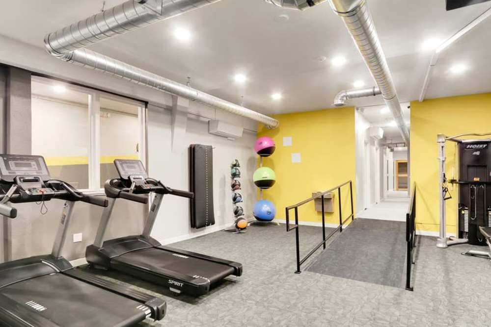 Fully equipped fitness center at Lantera Apartments in Seattle, Washington