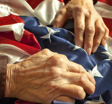 Elderly hands holding flag in Seattle, WA
