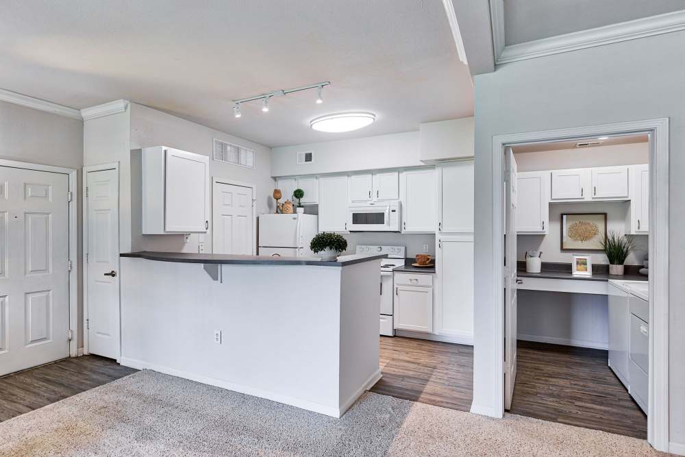 Modern kitchen with wooden cabinets, stainless-steel appliances and granite countertops at Eastland Trails in Independence, Missouri