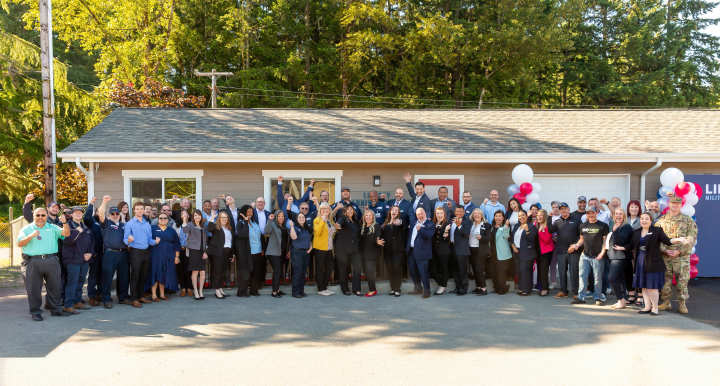 Attendees of the JBLM Training Academy ribbon cutting ceremony pose for a group photo