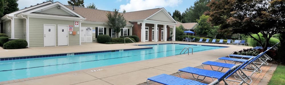Large swimming pool with tons of lounge chairs surrounding it at Cherokee Summit Apartments in Acworth, Georgia