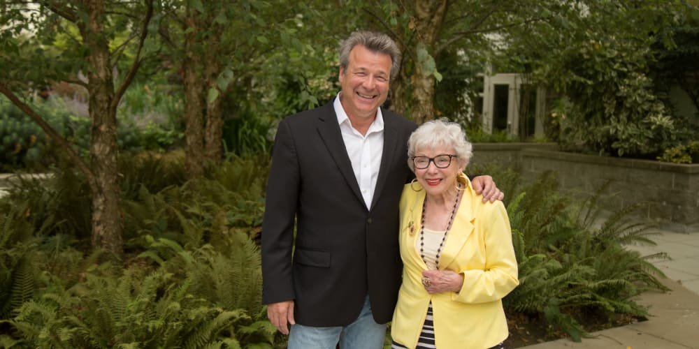 A staff member posing for a picture with a resident at Merrill Gardens at Auburn in Auburn, Washington. 