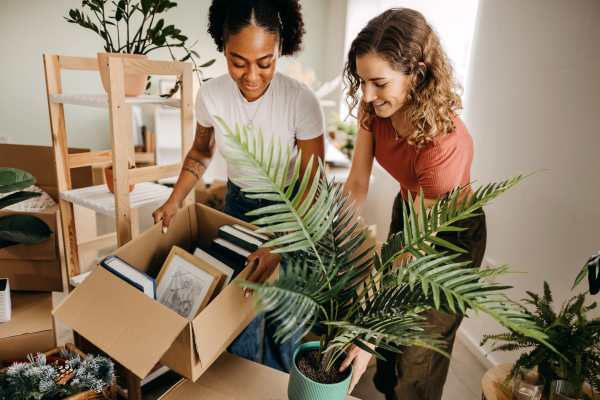 Two residents unpacking boxes in an apartment at Falls Creek in Sanford, North Carolina