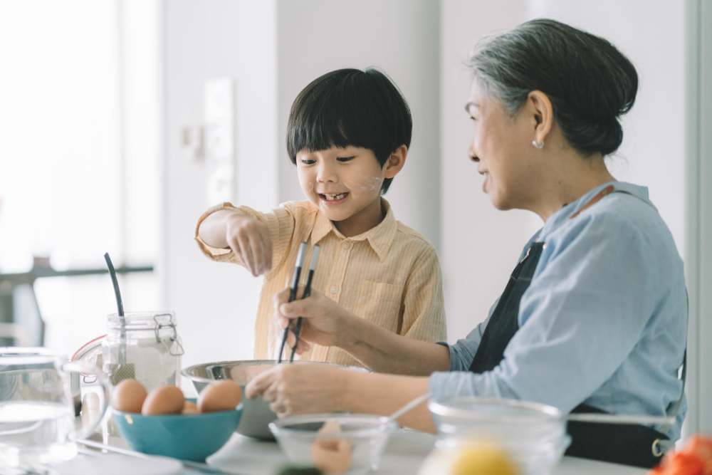 Kid helping grandmother in cooking at Palmer in Waldorf, Maryland