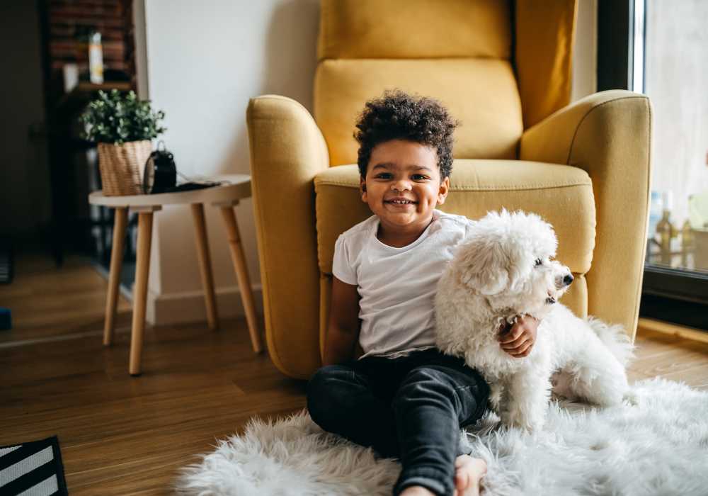 Kid at home with his dog at our pet-friendly apartments Ventura Park Plaza Apartments in Portland, Oregon