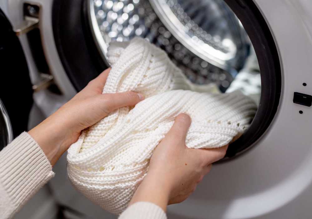 Resident putting cloths in laundry at Stonehurst Manor and Harrison Court in Upper Darby Township, Pennsylvania
