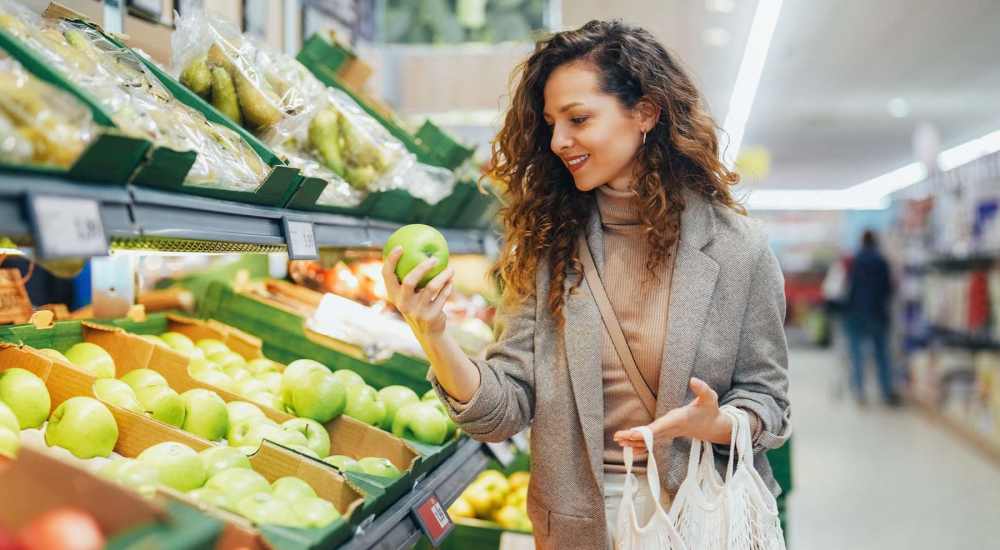 Resident buying fruits and vegetables in  a super-market near Huntington Reef in Huntington Beach, California