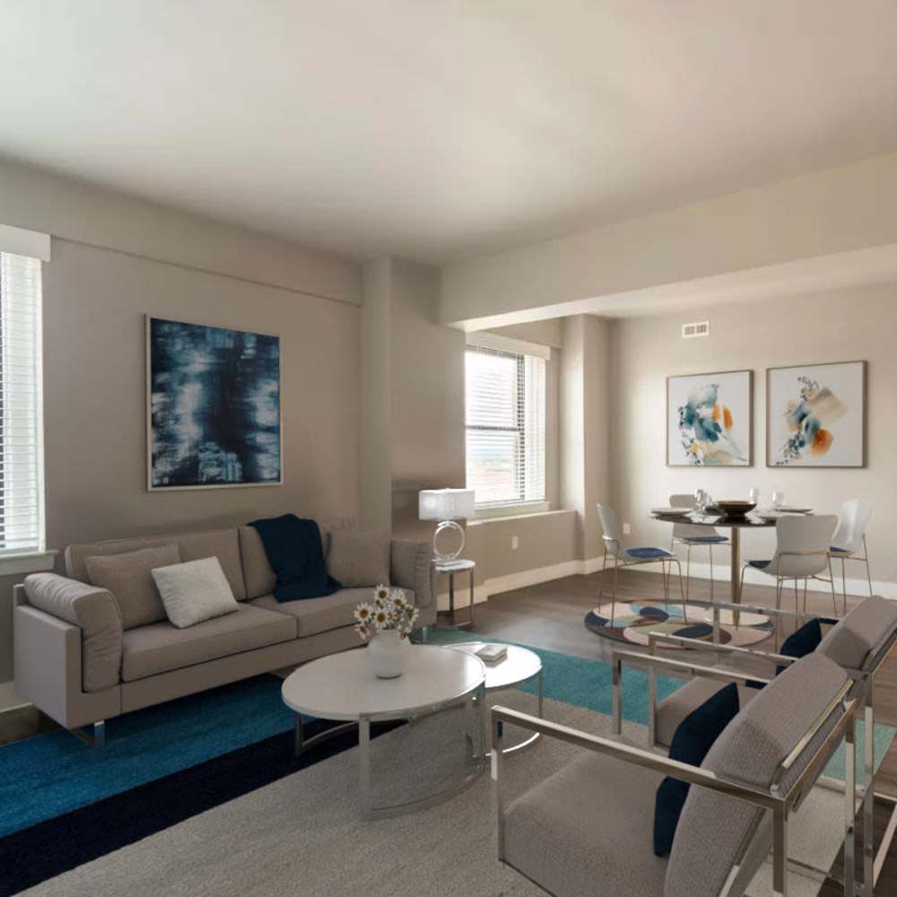 Spacious living area with modern furniture, dining table, and natural light from large windows at Flats on Fifth in Louisville, Kentucky