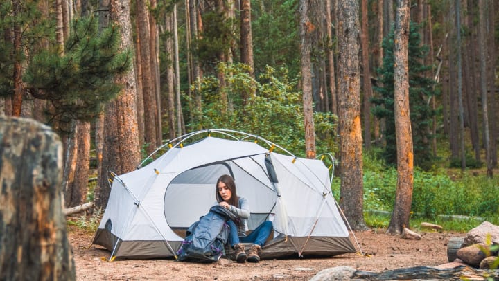 a lady camping in a tent 