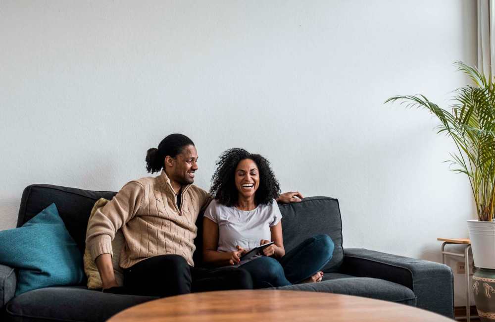 Resident couple seating in their new home at Arlington Gardens in Arlington, Massachusetts