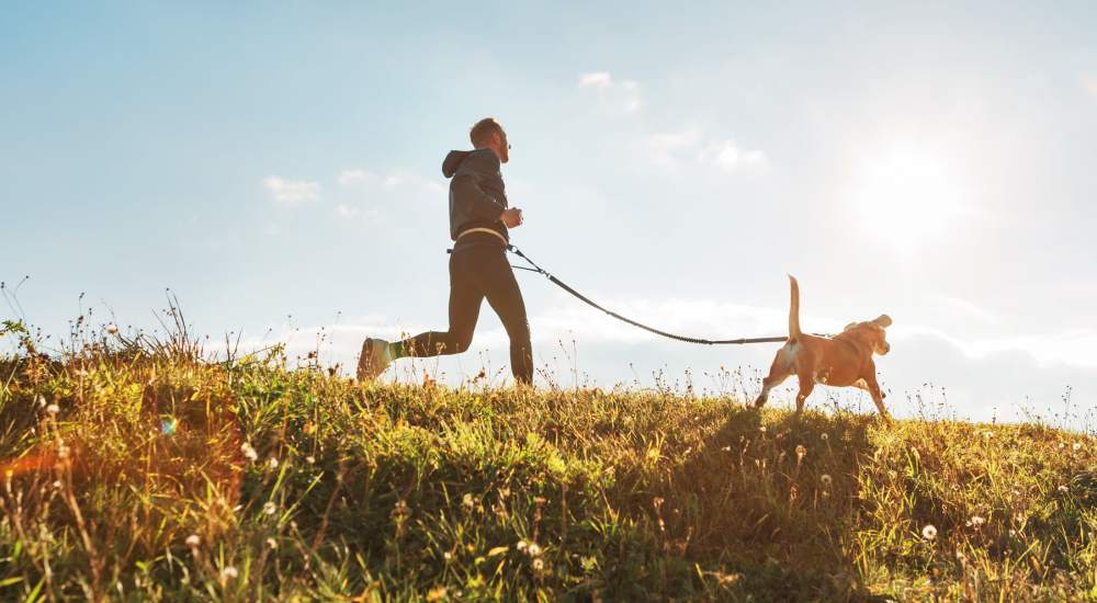 Resident running his dog near The Meadowlark at Fairview in Fairview, Oregon