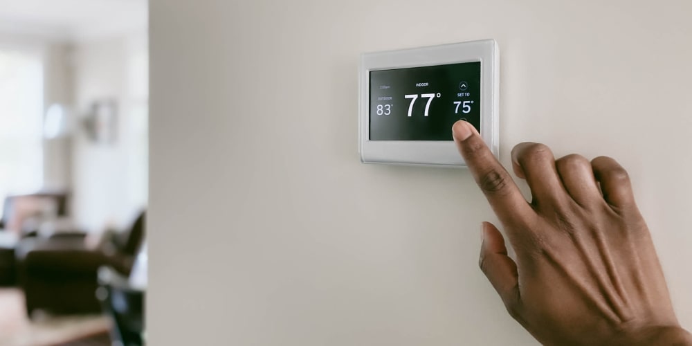 a customer changing a thermostat at Trojan Storage of Woodinville in Woodinville, Washington