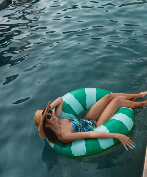 Resident lounging in the pool at Landmark Apartments Phase II in Little Rock, Arkansas