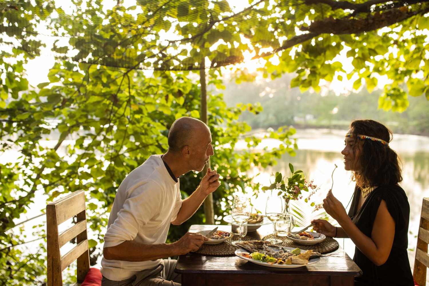Couple eating on a waterfront restaurant patio near Bramblewood in New Haven, Michigan