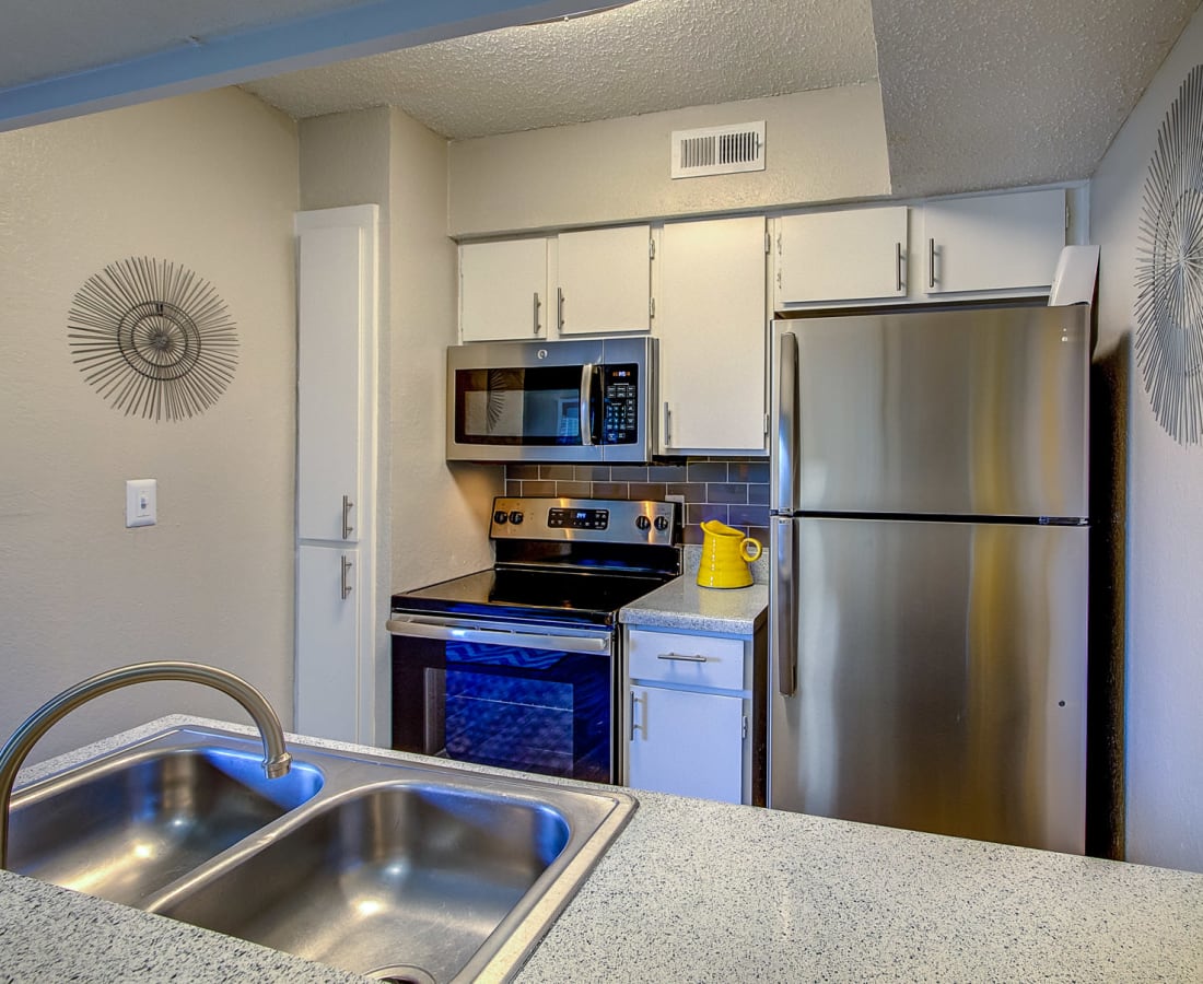 Stainless-steel appliances in an apartment kitchen at Canyon Grove in Grand Prairie, Texas