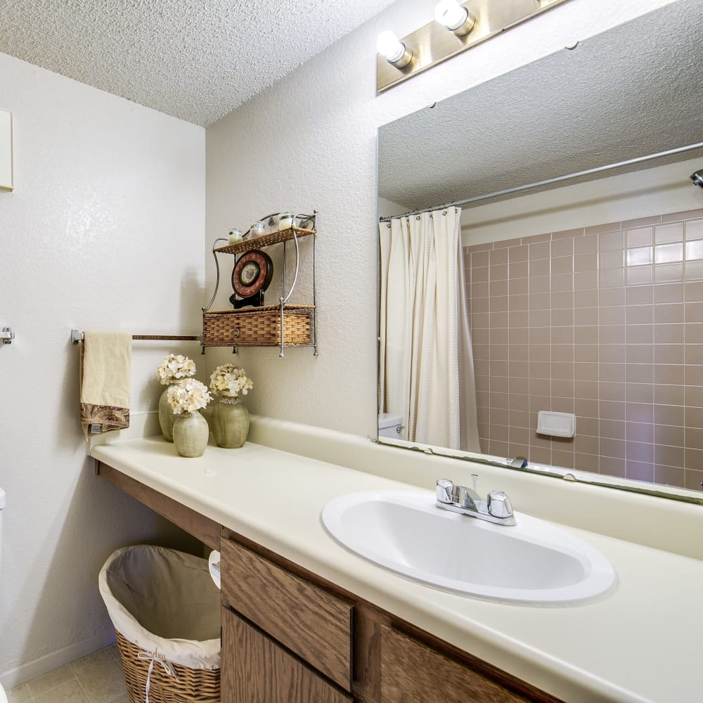 Bathroom with mirrors and plenty of lighting at Springhill Apartments in Overland Park, Kansas