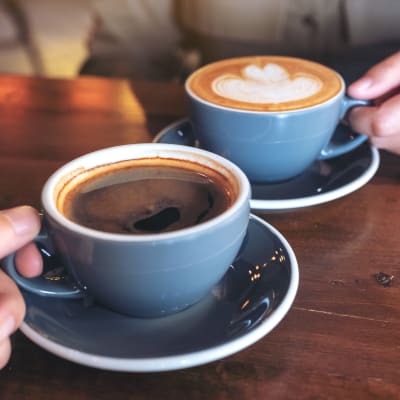 Hands with a coffee cups near Claremont Towers in Hillsborough, New Jersey