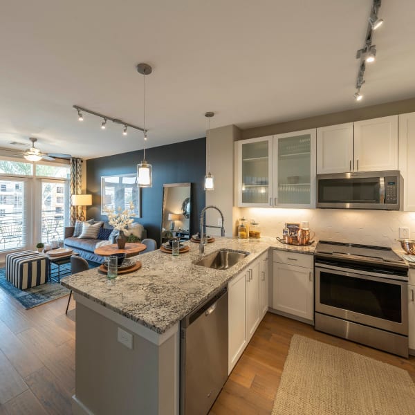 Gourmet kitchen overlooking the living space in a luxurious open-concept floor plan of a model home at Carter in Scottsdale, Arizona