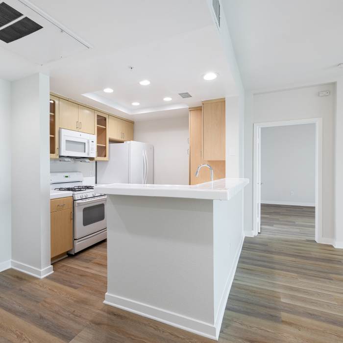 Bright apartment kitchen with white appliances at Capri Apartments in Marina Del Rey, California.