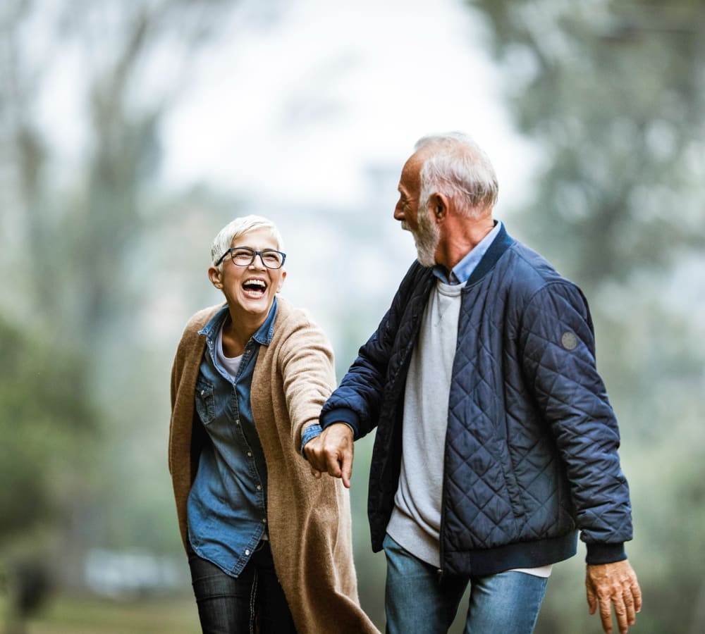 A resident couple taking a walk at Bridgeport Place Assisted Living in University Place, Washington.