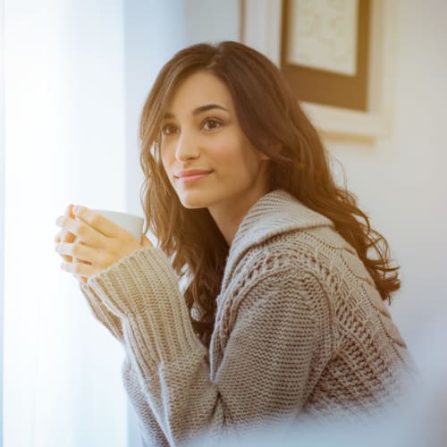 A resident holding a cup at Beech St. Knolls in San Diego, California