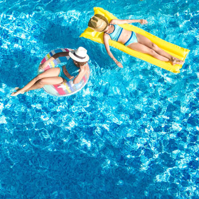 Residents floating in a swimming pool at Miramar Townhomes in San Diego, California