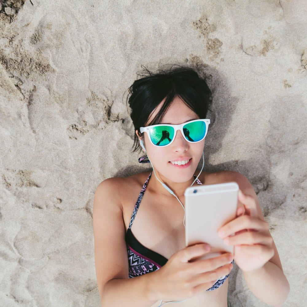 Resident texting on the beach near ICON in Isla Vista, California