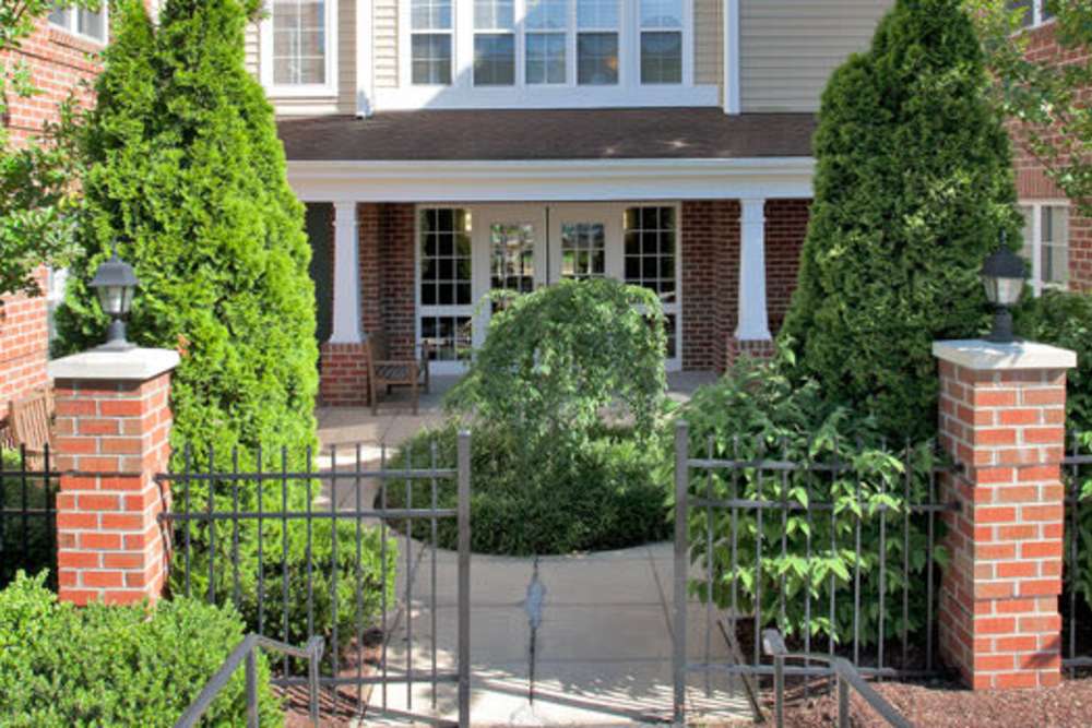 Building exterior with trees at The Willows Senior Community in Bowie, Maryland