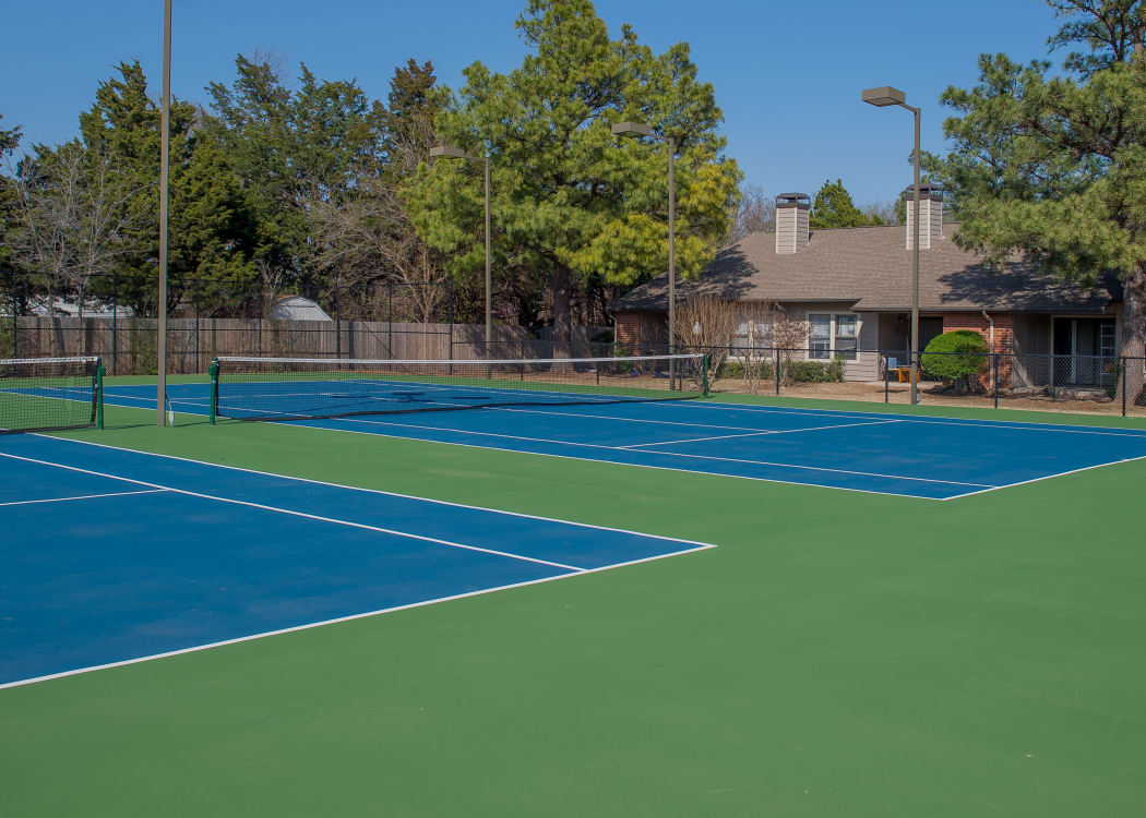 Tennis courts with lights at Woodscape Apartments in Oklahoma City, Oklahoma