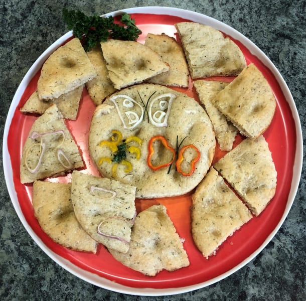 The focaccia was decorated with colorful and thinly cut veggies!