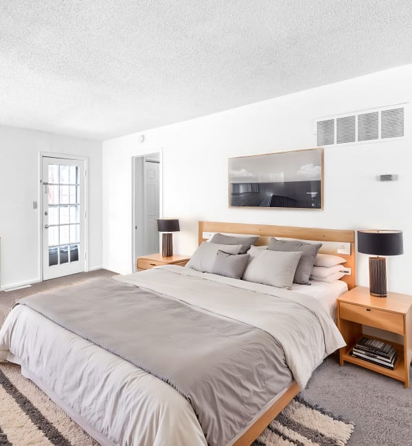 Bedroom with window at Georgetown Apartments in Merriam, Kansas