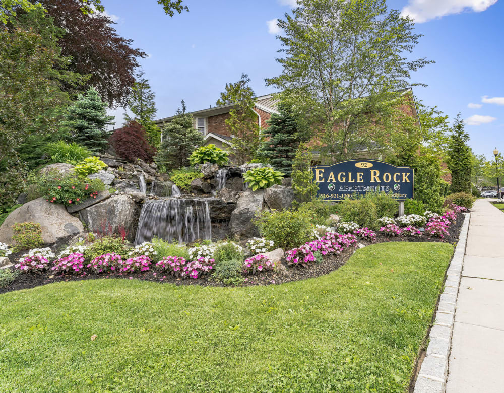 Entrance Sign and Beautiful Waterfall Feature at Eagle Rock Apartments at Woodbury in Woodbury, New York
