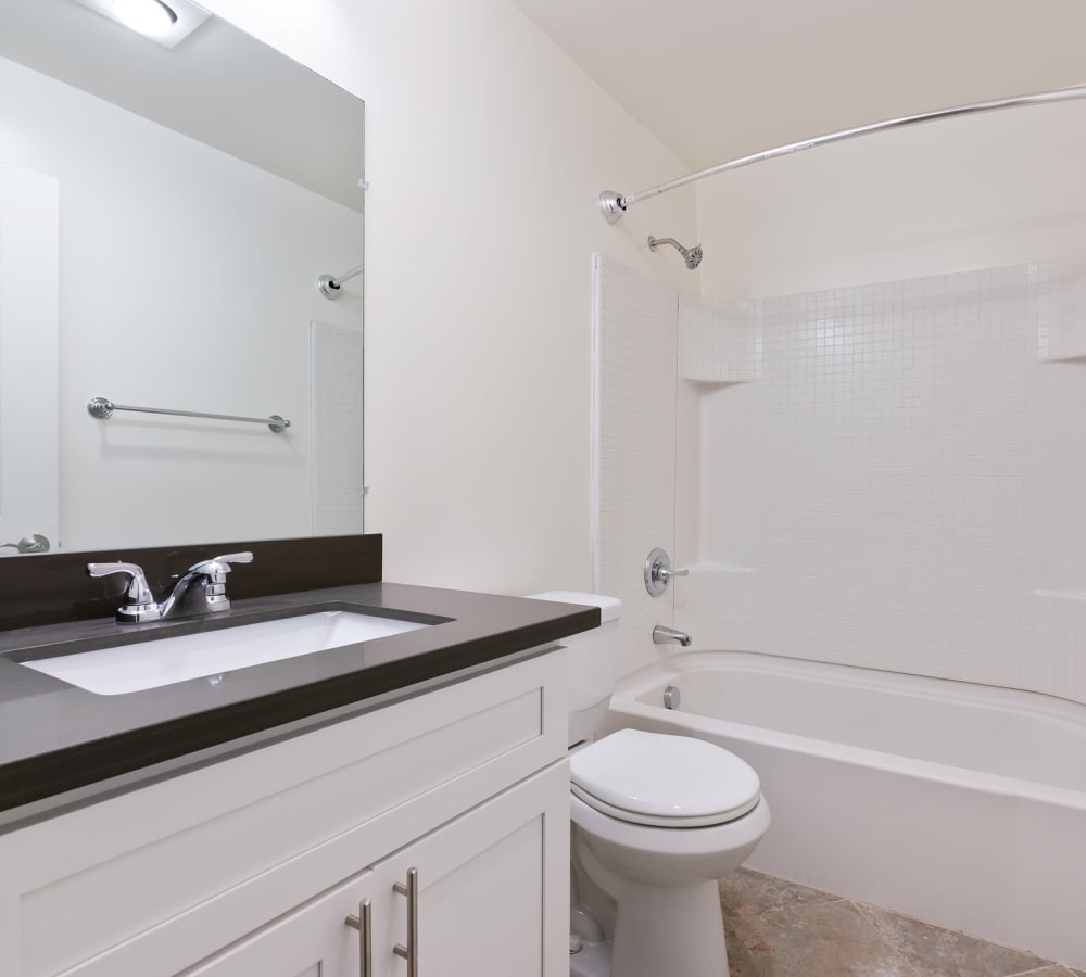 Bathroom with shower and white cabinets at Regency Plaza