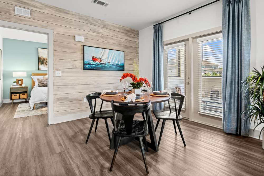 Spacious dining room with table, chairs and wood-style flooring at Watersound Origins Crossings in Inlet Beach, Florida