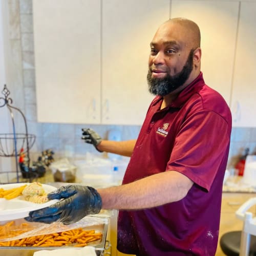 Head chef preparing a noodle based dish at Saddlebrook Oxford Memory Care in Frisco, Texas