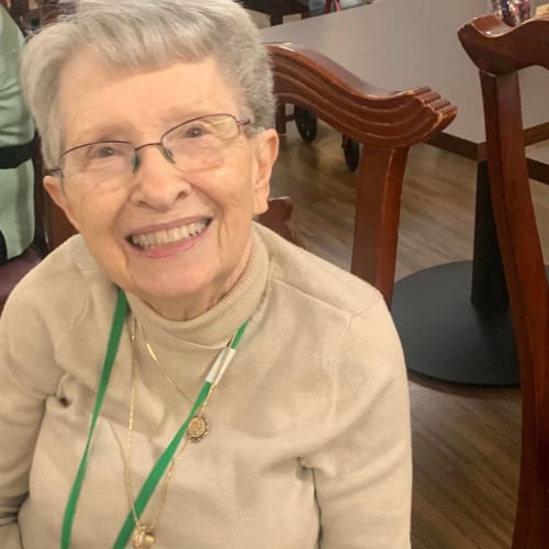 Happy resident at dinner at Canoe Brook Assisted Living in Broken Arrow, Oklahoma