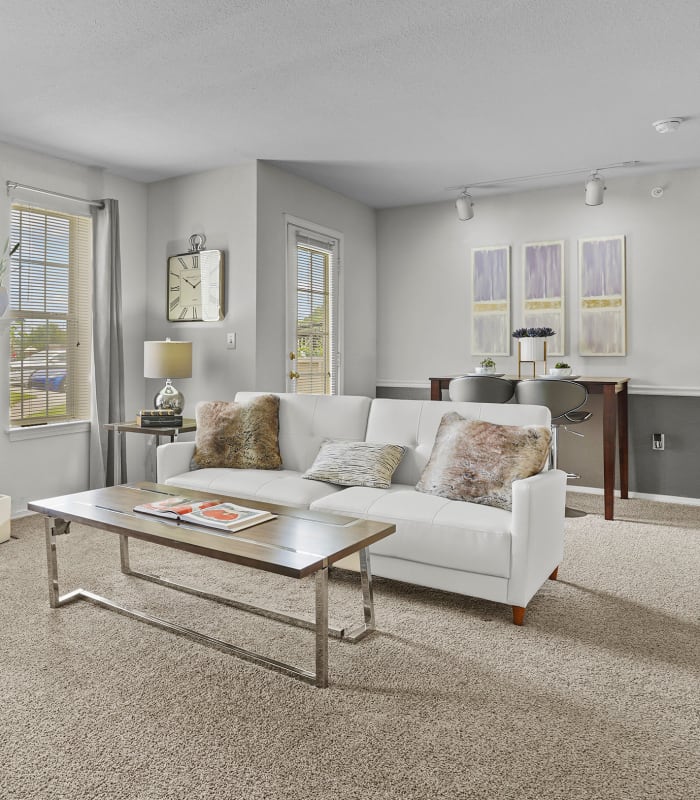 Carpeted living room and fireplace  at The Remington Apartments in Wichita, Kansas