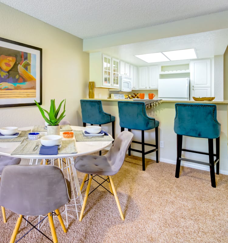 Dining area next to the kitchen's breakfast bar in a model home at Sofi Irvine in Irvine, California