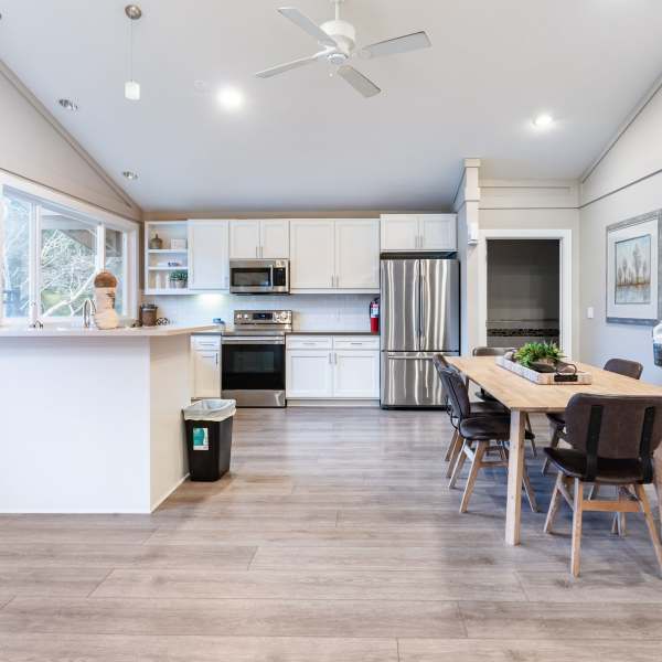 Modern kitchen with dining area at The Courtyard Apartment Homes in Mukilteo, Washington